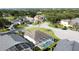 Aerial view of home featuring a screened in pool and lush green neighborhood at 2200 Mallory Cir, Haines City, FL 33844