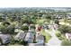 Beautiful residential neighborhood featuring lush green lawns, mature trees, and refreshing screened-in pools at 2200 Mallory Cir, Haines City, FL 33844