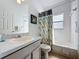Bathroom featuring a tub and shower, with a patterned curtain, toilet, and single sink vanity at 2200 Mallory Cir, Haines City, FL 33844