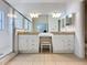 Bright bathroom featuring double sinks, large mirrors, vanity area, and a glass shower at 2200 Mallory Cir, Haines City, FL 33844