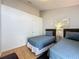 Bright bedroom features two twin beds and wood floor at 2200 Mallory Cir, Haines City, FL 33844