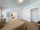 Comfortable bedroom featuring ensuite bath, closets, and a neutral carpet and decor at 2200 Mallory Cir, Haines City, FL 33844