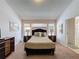 Cozy bedroom featuring soft lighting, a comfortable bed, and neutral decor at 2200 Mallory Cir, Haines City, FL 33844