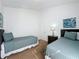 Cozy bedroom features two twin beds with soft teal comforters, and neutral walls at 2200 Mallory Cir, Haines City, FL 33844