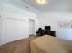 Bedroom featuring a work area, double closet, and a neutral carpet and decor at 2200 Mallory Cir, Haines City, FL 33844