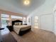 Spacious bedroom with a large window, ensuite bathroom, walk-in closet and neutral carpeting at 2200 Mallory Cir, Haines City, FL 33844