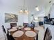 Bright dining area featuring a stylish chandelier and an abstract painting on the wall at 2200 Mallory Cir, Haines City, FL 33844