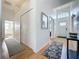Inviting entryway featuring a high ceiling, coat closet, and decorative rugs on wood-look flooring at 2200 Mallory Cir, Haines City, FL 33844