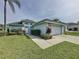 Charming single-Gathering home with a well-manicured lawn, a two-car garage, and lovely landscaping at 2200 Mallory Cir, Haines City, FL 33844