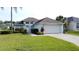 Charming single-story home with well-manicured lawn and attached two-car garage, perfect for Gathering living at 2200 Mallory Cir, Haines City, FL 33844