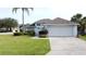 Charming single-Gathering home with a well-manicured lawn, a two-car garage, and lovely landscaping at 2200 Mallory Cir, Haines City, FL 33844