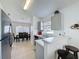 Kitchen featuring bar seating and views into the dining area with lots of natural light at 2200 Mallory Cir, Haines City, FL 33844