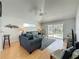 Bright living room featuring stylish seating, a ceiling fan, and sliding doors to the pool area at 2200 Mallory Cir, Haines City, FL 33844