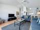 Living room offers comfortable seating, a ceiling fan, and flows easily into the kitchen at 2200 Mallory Cir, Haines City, FL 33844