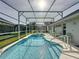Enclosed pool area with a clear blue pool, tile trim, and multiple seating areas at 2200 Mallory Cir, Haines City, FL 33844