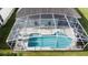 Aerial view of a screened-in pool with blue water and outdoor seating at 2200 Mallory Cir, Haines City, FL 33844