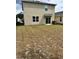 A partially grassed backyard with sliding glass door access to the home at 2655 Swooping Sparrow Dr, Harmony, FL 34773