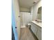 Bright bathroom with a sink, shower, and white cabinets at 2655 Swooping Sparrow Dr, Harmony, FL 34773