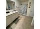 Bright bathroom featuring a vanity with sink and a shower with a decorative curtain at 2655 Swooping Sparrow Dr, Harmony, FL 34773