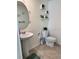 Bathroom with a pedestal sink and ceramic tile flooring, offering a clean and simple design at 2655 Swooping Sparrow Dr, Harmony, FL 34773