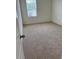 Neutral carpeted bedroom with a window allowing natural light at 2655 Swooping Sparrow Dr, Harmony, FL 34773