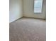 Neutral carpeted bedroom with a window offering natural light at 2655 Swooping Sparrow Dr, Harmony, FL 34773
