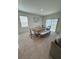 Bright dining room featuring a wooden table with bench seating and sliding glass doors to the backyard at 2655 Swooping Sparrow Dr, Harmony, FL 34773