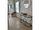 A glimpse of a stylish foyer featuring tile flooring and decorative console table at 2655 Swooping Sparrow Dr, Harmony, FL 34773