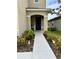 Inviting front porch with decorative plants and a clear walkway to the entrance at 2655 Swooping Sparrow Dr, Harmony, FL 34773