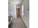 Hallway area with view of the dining room and walk-in closet in a home with neutral paint scheme at 2655 Swooping Sparrow Dr, Harmony, FL 34773