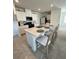 A kitchen island with barstool seating is centered in this well-appointed space at 2655 Swooping Sparrow Dr, Harmony, FL 34773