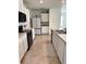 Well-lit kitchen featuring modern appliances, ample cabinet space and tile flooring at 2655 Swooping Sparrow Dr, Harmony, FL 34773