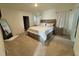 Bedroom with a king-size bed, neutral decor, and large windows offering plenty of natural light at 2655 Swooping Sparrow Dr, Harmony, FL 34773