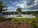 Relaxing community pool with lounge chairs and beautiful landscaping under partly cloudy skies at 2655 Swooping Sparrow Dr, Harmony, FL 34773