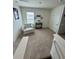 Upstairs area featuring a cozy chair and table, illuminated by a window for natural light at 2655 Swooping Sparrow Dr, Harmony, FL 34773