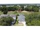 Aerial view of home nestled among lush trees, with a nearby golf course and glistening lake at 2692 Hemingway Ave, Haines City, FL 33844