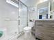 Bright bathroom features tiled shower/tub combo and modern gray vanity with white countertop at 2692 Hemingway Ave, Haines City, FL 33844