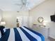 Comfortable bedroom with a ceiling fan, ensuite bathroom, and a bright interior that is inviting and relaxing at 2692 Hemingway Ave, Haines City, FL 33844