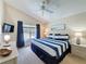 Comfortable bedroom with a ceiling fan, a poolside view, and a soothing blue and white color scheme at 2692 Hemingway Ave, Haines City, FL 33844