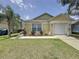 Charming single-story home with a well-manicured lawn, attached garage and neutral color palette at 2692 Hemingway Ave, Haines City, FL 33844