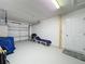 Spacious garage featuring painted floor and abundant space for car storage and projects at 2692 Hemingway Ave, Haines City, FL 33844