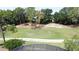 Golf course view from behind screen featuring lush grass and mature trees at 2692 Hemingway Ave, Haines City, FL 33844