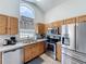 Well-equipped kitchen with stainless steel appliances and wood cabinets, perfect for home cooking at 2692 Hemingway Ave, Haines City, FL 33844