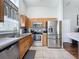 Well-equipped kitchen with stainless steel appliances and wood cabinets, perfect for home cooking at 2692 Hemingway Ave, Haines City, FL 33844