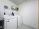 Cozy laundry room featuring white washer and dryer, with shelving and storage space above at 2692 Hemingway Ave, Haines City, FL 33844