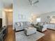 Open-concept living space with hardwood floors, comfortable seating, and stylish decor accents at 2692 Hemingway Ave, Haines City, FL 33844