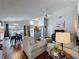 Cozy living room flowing into the kitchen and dining area, featuring hardwood floors at 2692 Hemingway Ave, Haines City, FL 33844