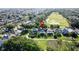 Residential area showcases green fairways, mature trees, and the tranquil community, as seen from above at 2696 Hemingway Ave, Haines City, FL 33844