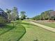 Lush green backyard featuring a serene golf course view, perfect for outdoor enjoyment and relaxation at 2696 Hemingway Ave, Haines City, FL 33844