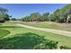 Expansive green backyard offering tranquil golf course views, perfect for outdoor activities and relaxation at 2696 Hemingway Ave, Haines City, FL 33844